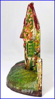 LATE 19TH C ANTIQUE CAST IRON COTTAGE DOORSTOP IN ORIG PAINT, WithFENCING, FLOWERS