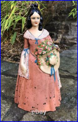 Original antique cast iron Victorian woman in pink dress and hat doorstop c1870