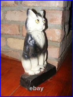 VINTAGE CAST IRON SITTING BLACK and white kitty CAT DOORSTOP patina antique 12